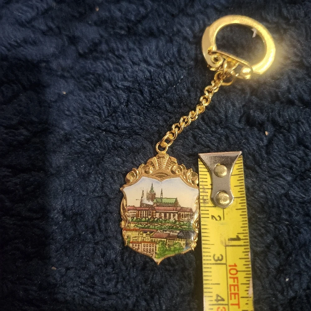 Vintage souvenir keychain a painted enamel depiction of Prague Castle